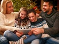 Happy family time - family using digital tablet on Christmas holidays. Royalty Free Stock Photo